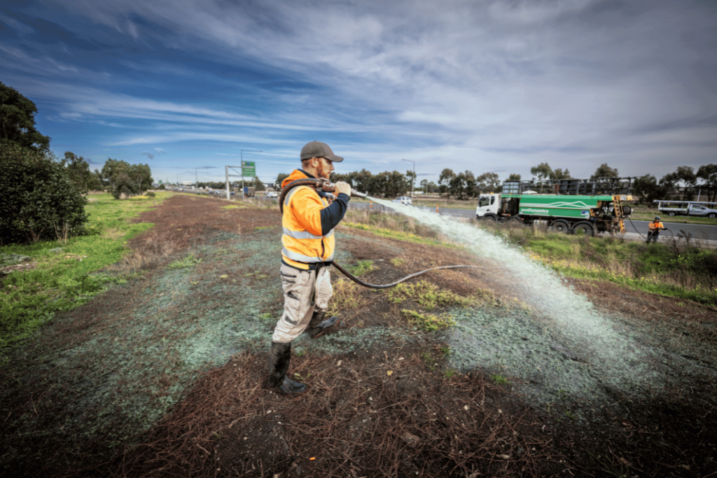 Hydroseeding with a hose from a hydromulcher truck