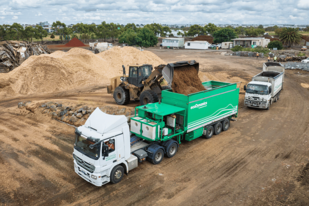 A blower truck being loaded with mulch, which is one of the ways we can install mulch