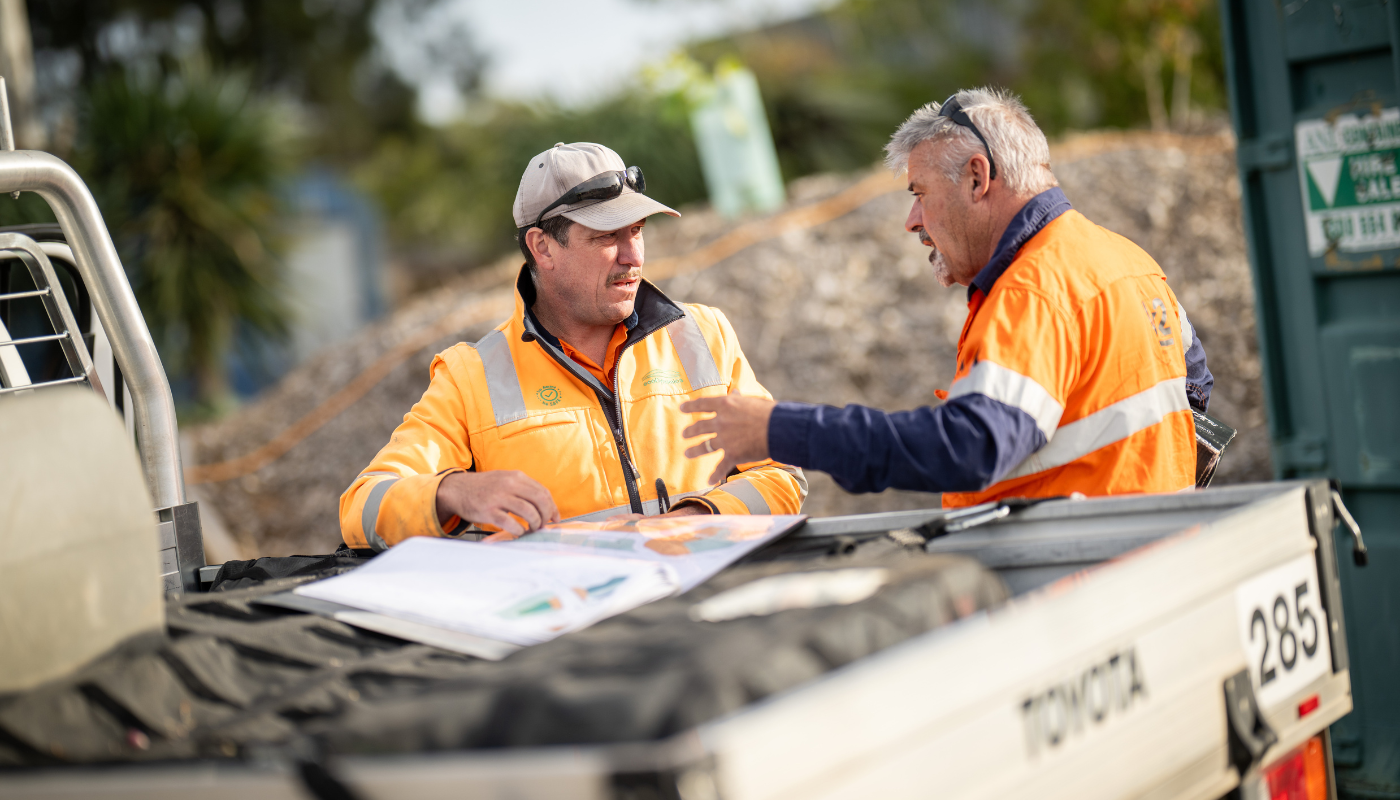 two ecoDynamics workers talking and showing training and support