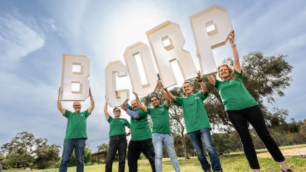 ecoDynamics employees holding B Corp letters